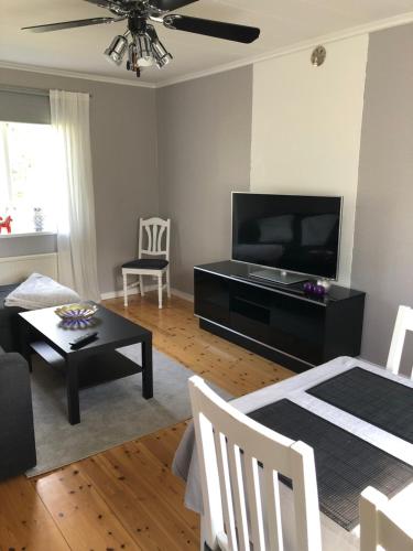 a living room with a television and a table at Entire cabin - Mora, Selja, cabin in village environment for 4 persons in Mora