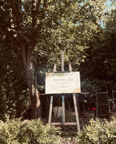 a sign for the victorian hall in front of a tree at Maison Lily Apartment 1 in Bad Lauterberg