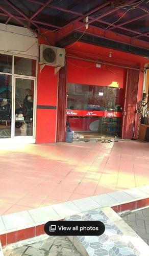 a store front with a red wall and windows at Chandrady Permata Guest House 2 in Jakarta