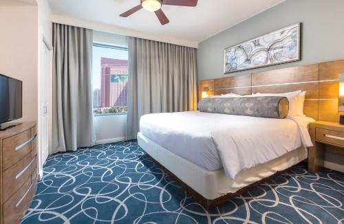 a hotel room with a bed and a television at Wyndham Desert Blue 2BR Villa with Resort Access in Las Vegas