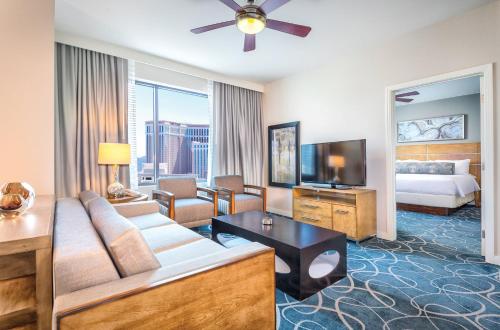 a living room with a couch and a bed and a television at Wyndham Desert Blue 2BR Villa with Resort Access in Las Vegas
