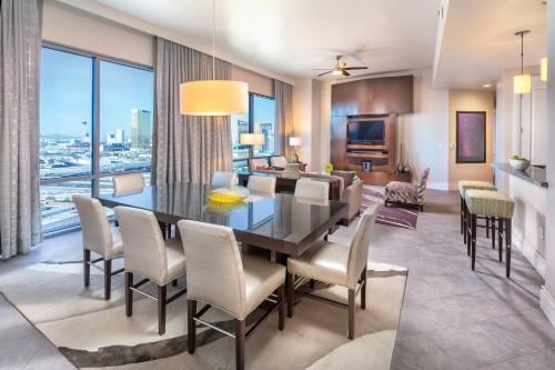 a dining room with a table and chairs and a living room at Wyndham Desert Blue 2BR Villa with Resort Access in Las Vegas