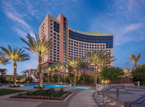 a hotel with palm trees in front of a building at Wyndham Desert Blue 3BR Villa with Resort Access in Las Vegas