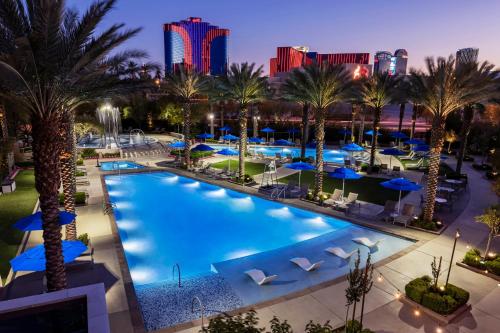 an overhead view of a pool with palm trees and hotels at Wyndham Desert Blue 3BR Villa with Resort Access in Las Vegas