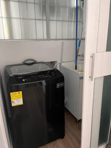 a small refrigerator in a room with a wall at alojamiento en apartamento moderno in Manizales