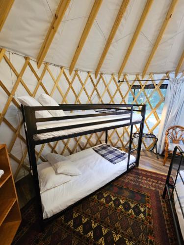 a bedroom in a yurt with a bunk bed at Roamstead Smoky Mountains in Cosby