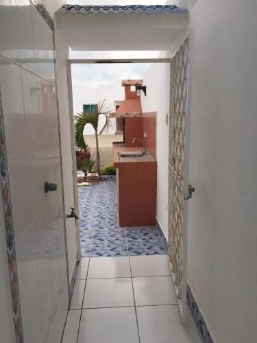 a hallway leading to a kitchen with a sink at VILLA AMOBLADA URB CIUDAD PUNTA CARNERO Salinas in Salinas