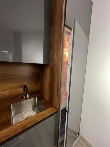 a kitchen with a sink next to a door at Art superior apartment in Kosovo Polje