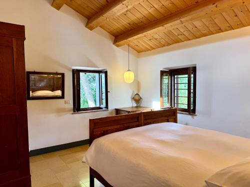 a bedroom with a large bed and a window at Casa Ancarano Historic Cottage Panoramic position sea 3km 4-8pers in Sirolo