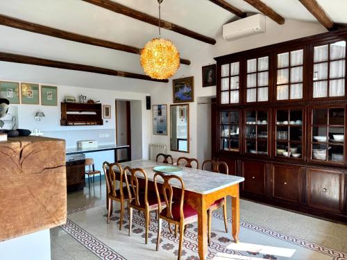 a kitchen and dining room with a table and chairs at Casa Ancarano Historic Cottage Panoramic position sea 3km 4-8pers in Sirolo