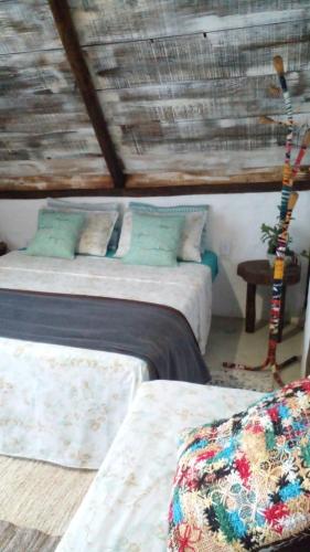 En eller flere senge i et værelse på Cabana Sem'ente Paraty