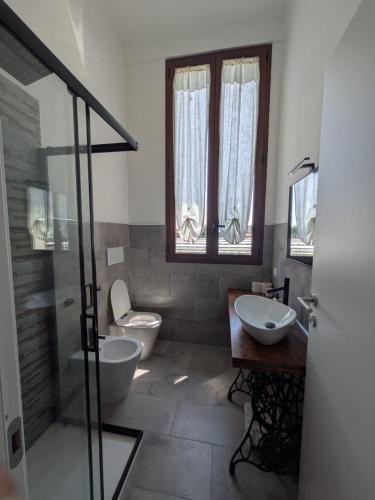 a bathroom with a toilet and a sink and a shower at Casetta del Sole in Vallecrosia