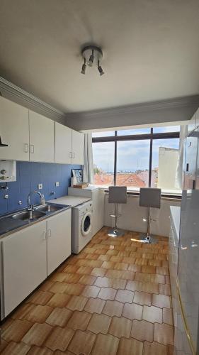 a kitchen with a sink and a washing machine at Historic center apartment Cascais in Cascais
