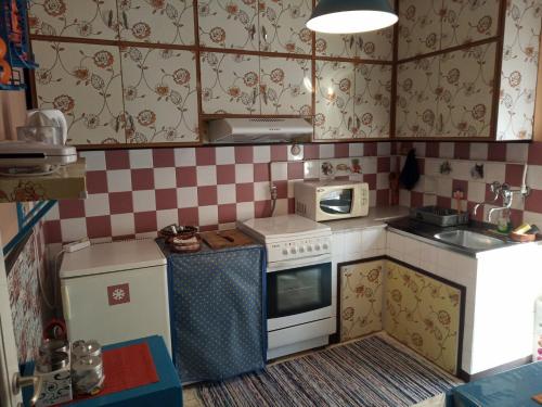 a small kitchen with a toy stove and microwave at Cosy Penthouse -up to 6 guests- in the City Centre! in Thessaloniki
