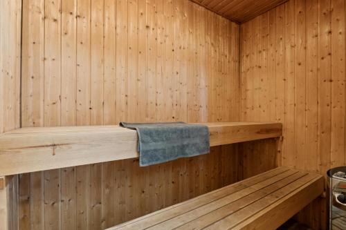 a sauna with a towel on a wooden wall at Energy-Efficient Pool House Located Between The Sea And The Fjord in Ringkøbing