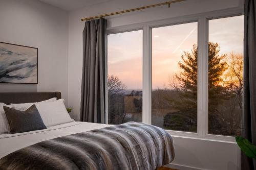 a bedroom with a bed and a large window at Coachella -An Atomic Ridge Home in Chattanooga
