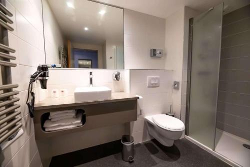 a bathroom with a sink and a toilet and a shower at Best Western Eden SPA in Honfleur