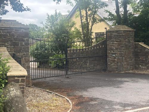an iron gate in front of a house at Hayes Lodge Coach House in Chulmleigh