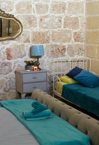 Postel nebo postele na pokoji v ubytování Tal-Bambinu Boutique B&B
