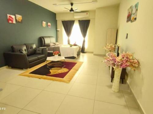 a living room with a couch and a table at EduStay Lofts - Cyber University Circle in Cyberjaya
