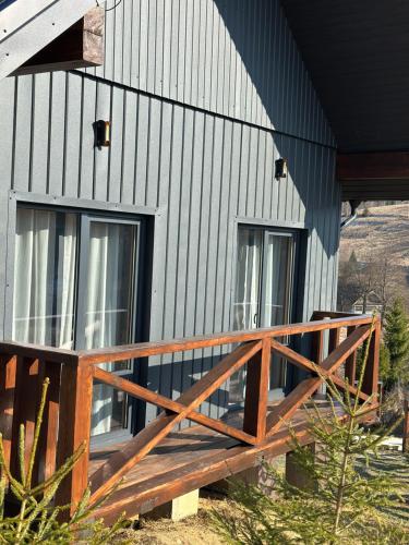 a house with a wooden deck on the side of it at Шервуд in Myta
