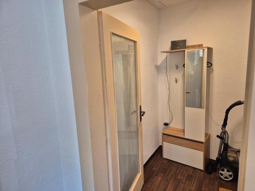 a bathroom with a mirror and a walk in shower at Neue Gäste Ferienwohnung in Geringswalde