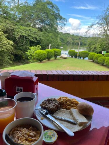 a table with a plate of food on a table at Hostería Florida Tropical in Santa Fe de Antioquia