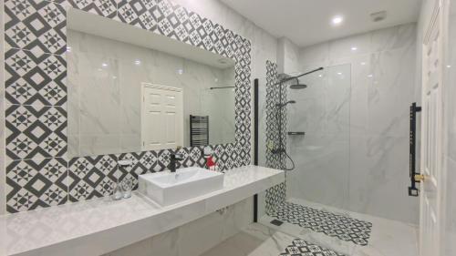 a bathroom with a sink and a shower and a mirror at Muthu Fort William Hotel in Fort William