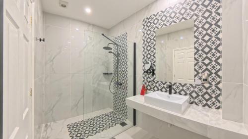 a bathroom with a shower and a sink and a mirror at Muthu Fort William Hotel in Fort William