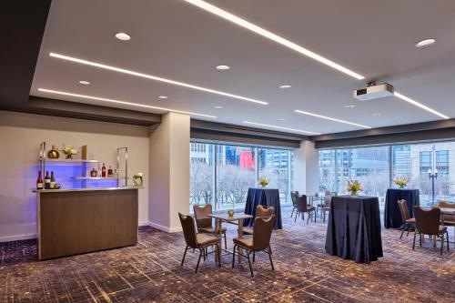 a conference room with tables and chairs and a bar at Loews Chicago Hotel in Chicago