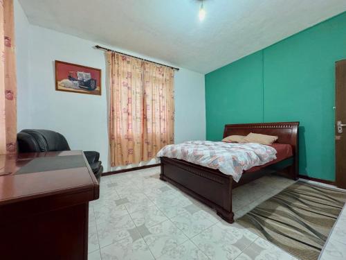 a bedroom with a bed and a desk and a window at Transit Home Lower Level - 10 mins from Airport and Blue bay in Mare dʼAlbert