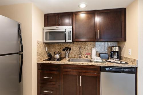 a kitchen with a sink and a microwave at The Berkley, Las Vegas in Las Vegas