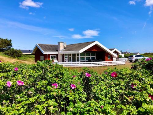 a house with pink flowers in front of it at Lovely cottage on Rømø in Rømø