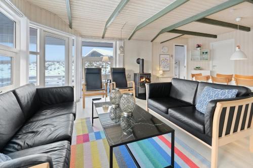 a living room with a couch and a table at Lovely cottage on Rømø in Rømø