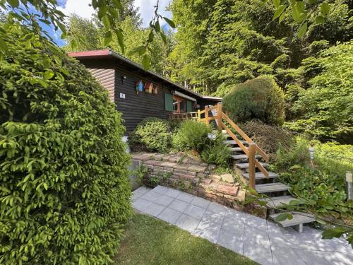 a house with a wooden staircase leading to a garden at Haus Anna in Stadlern