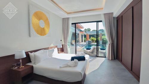 a hotel room with a bed and a balcony at Santi Tara Villas in Amphoe Koh Samui