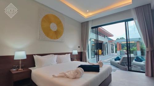 a bedroom with a bed with a stuffed animal on it at Santi Tara Villas in Amphoe Koh Samui
