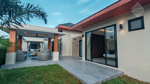 a home with a patio and a house at Santi Tara Villas in Amphoe Koh Samui