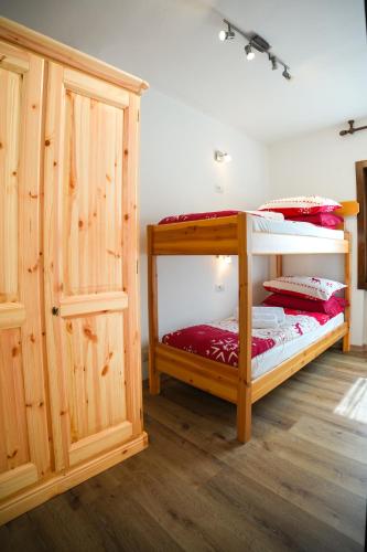 a bedroom with two bunk beds and a closet at LAB House in Madonna di Campiglio