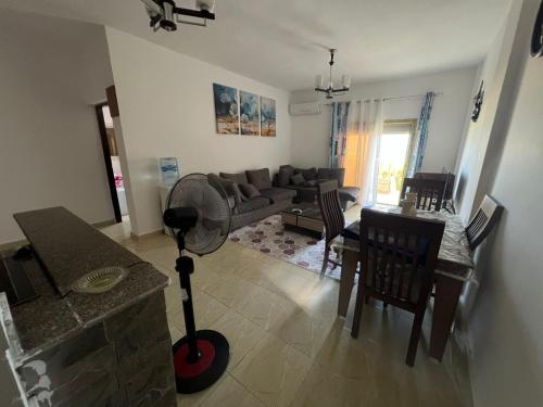 a living room with a couch and a table with a fan at Your Perfect Getaway, Luxury Chalet in Lamera, Ras El Hekma in Zāwiyat al ‘Awwāmah