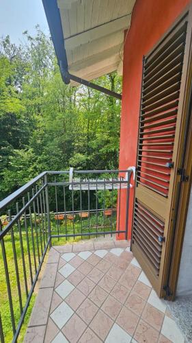 an open door to a balcony with a fence at Agriturismo dei Laghetti in Porto Valtravaglia