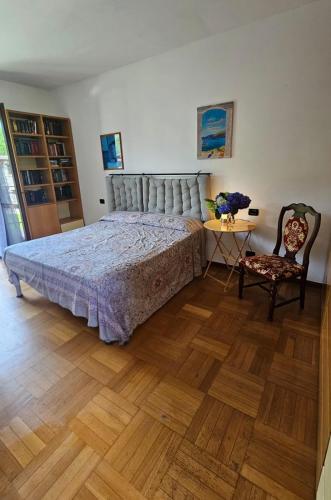 a bedroom with a bed and a table and a chair at Agriturismo dei Laghetti in Porto Valtravaglia