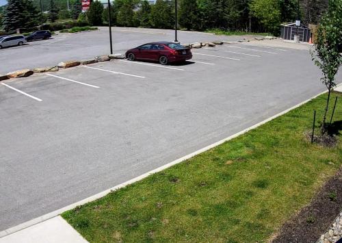 a parking lot with a red car parked in it at Home2 Suites By Hilton Huntsville in Huntsville