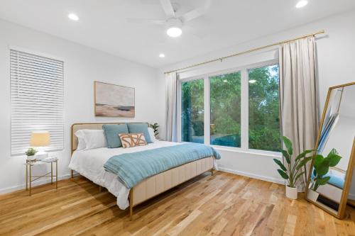 a bedroom with a bed and a large window at Azul - An Atomic Ridge Home in Chattanooga