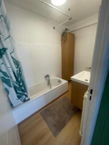 a bathroom with a bath tub and a sink at Appartement à vence in Vence