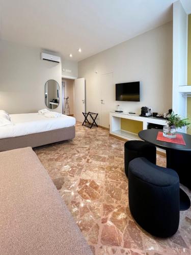 a hotel room with a bed and a table at Casa Almika Abate Gimma in Bari