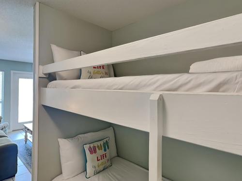 a bedroom with two bunk beds with pillows at Grand Caribbean Perdido Key #306 West in Perdido Key