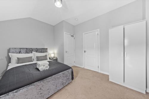 a bedroom with a large bed with white cabinets at Modern Bannockburn Guest House - Ensuite Rooms Only in Bannockburn