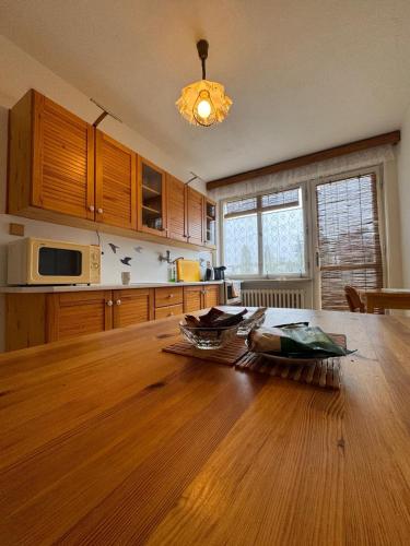 a kitchen with a wooden table and a dining room at Apartmán Kyjov in Kyjov