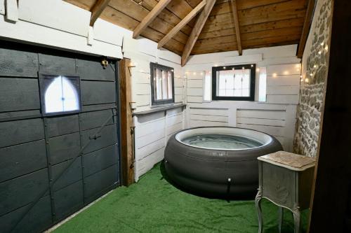 a bathroom with a large tub in a house at La grange de Louise in La Chapelle-Taillefert